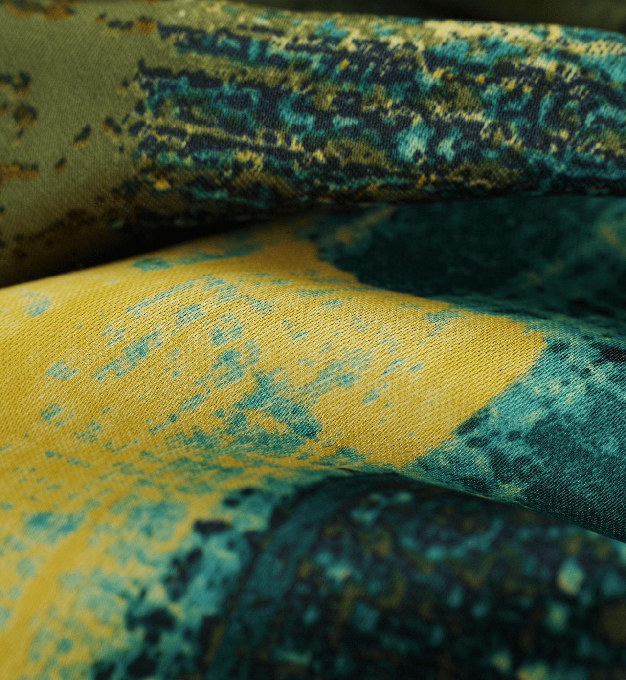 Close-up of green and yellow abstract patterned fabric with artistic texture